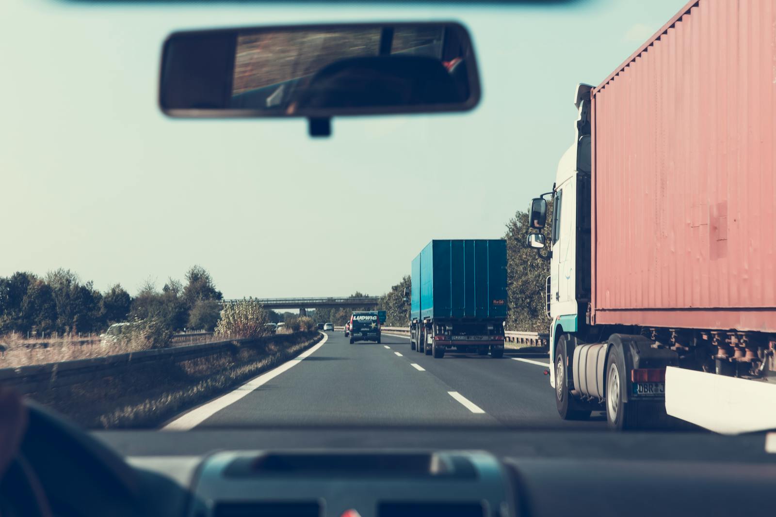 truck, trucking, View through rearview mirror of trucks on a German highway, driving towards Bamberg.